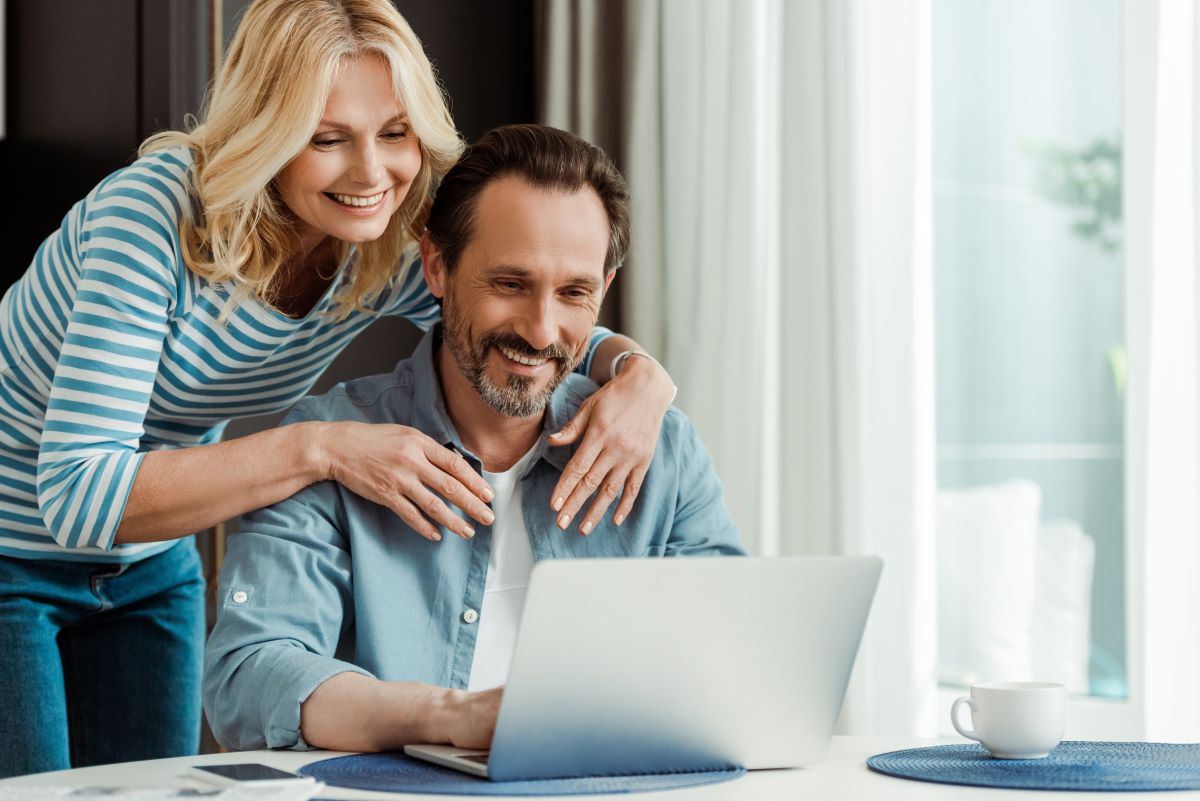 Couple looking at a laptop screen